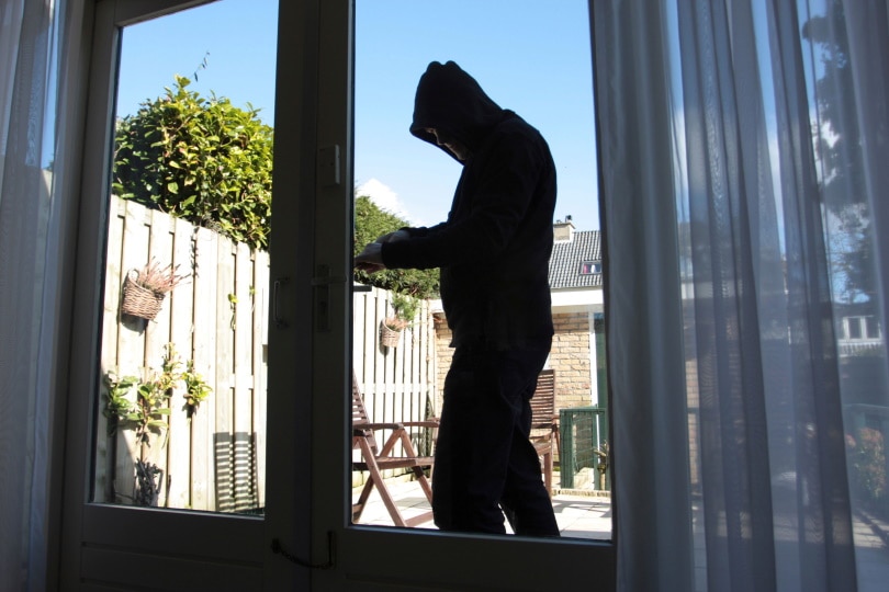 man trying to break house door