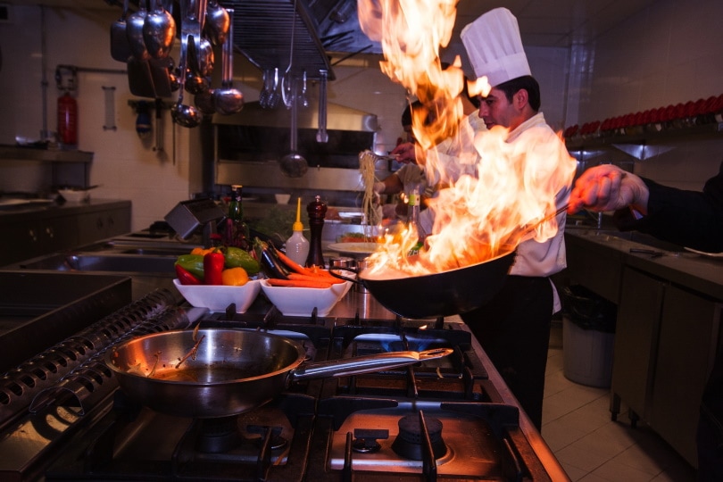 person cooking food in the kitchen