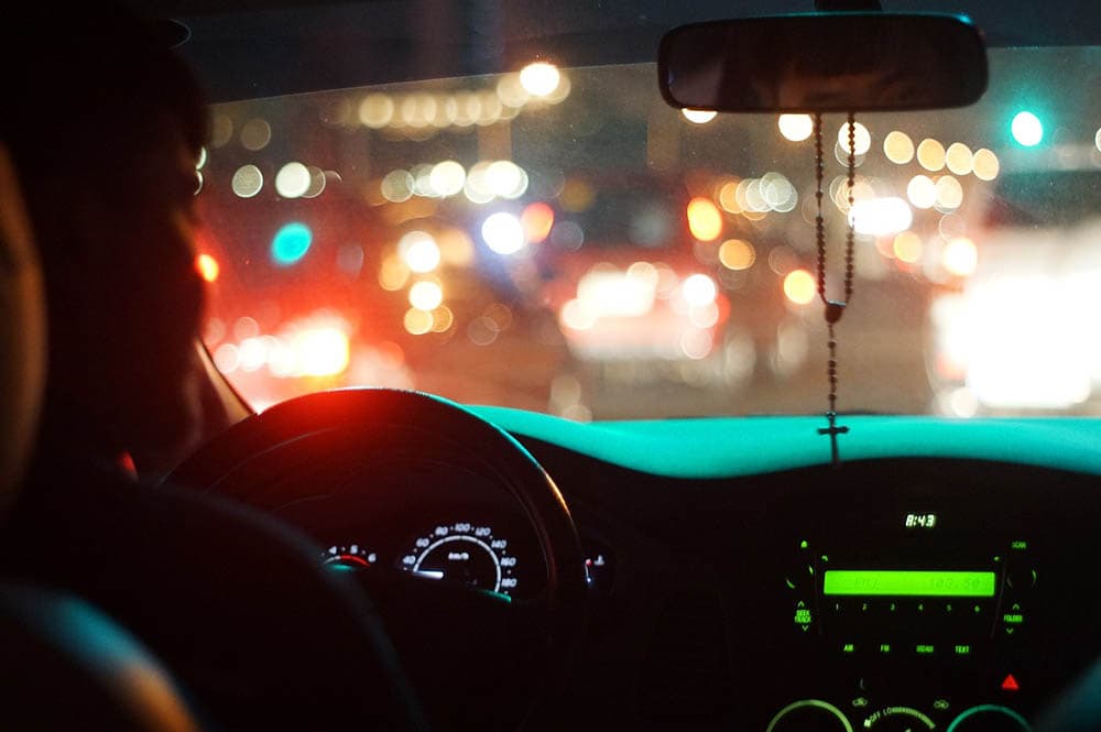 person driving at night
