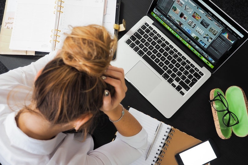 woman sitting in front of her laptop
