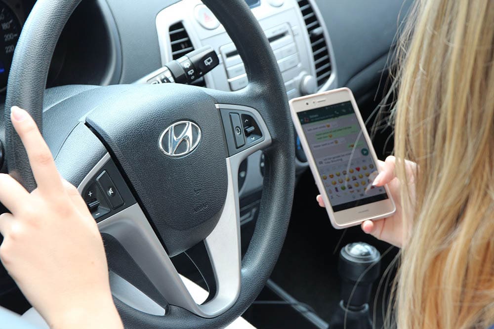 woman texting while driving