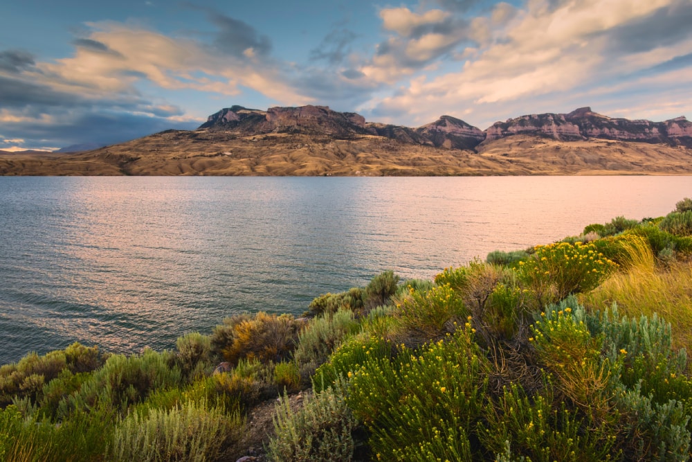 Cody, Wyoming, USA - View across the Shoshone river and reservoir flanked by the foothills of the Rockies