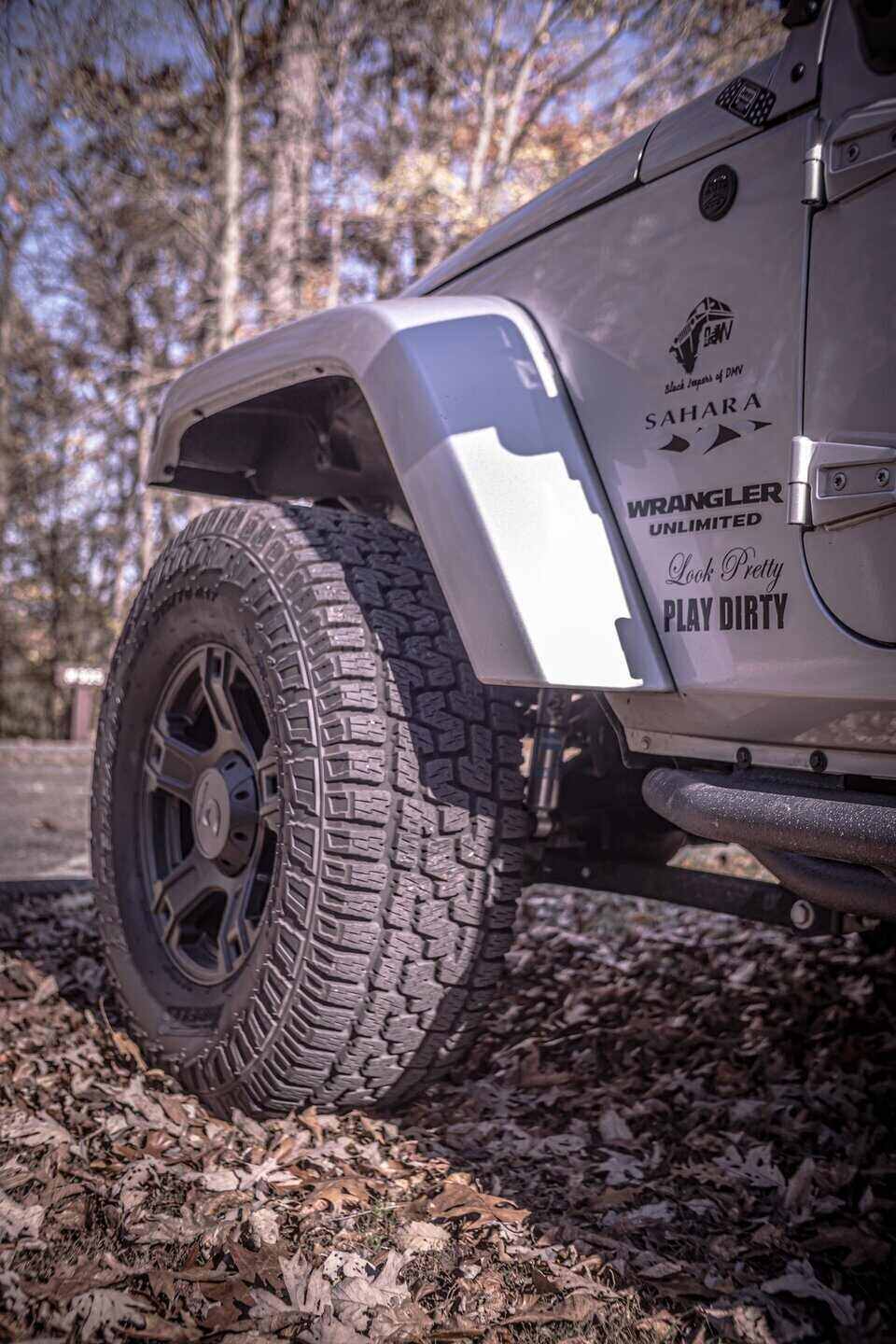 Silver Jeep Parked on Dirt Road with vinyl