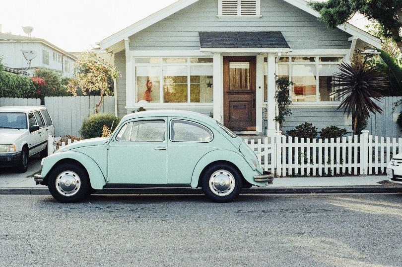 beetle parked in front of a house