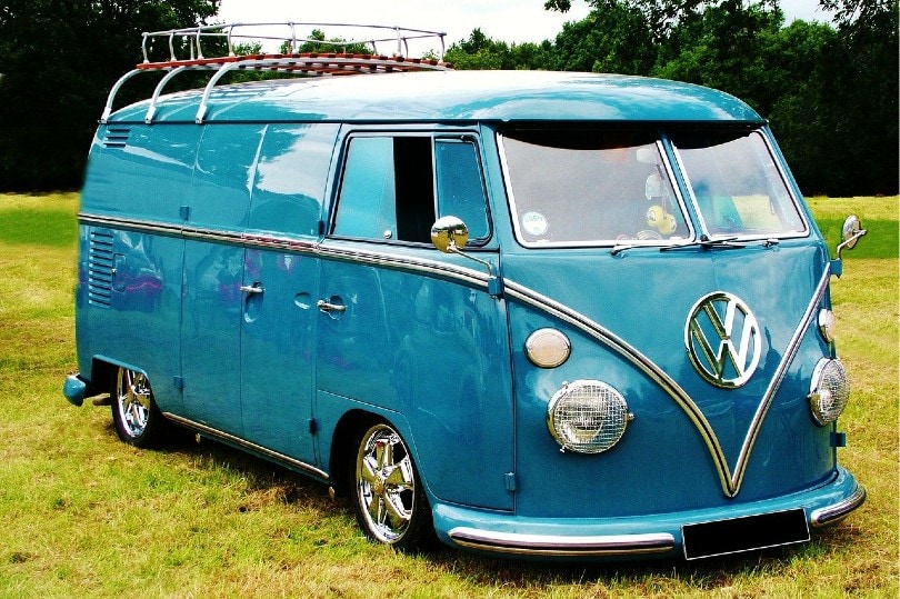 blue volkswagen van parked in an open field