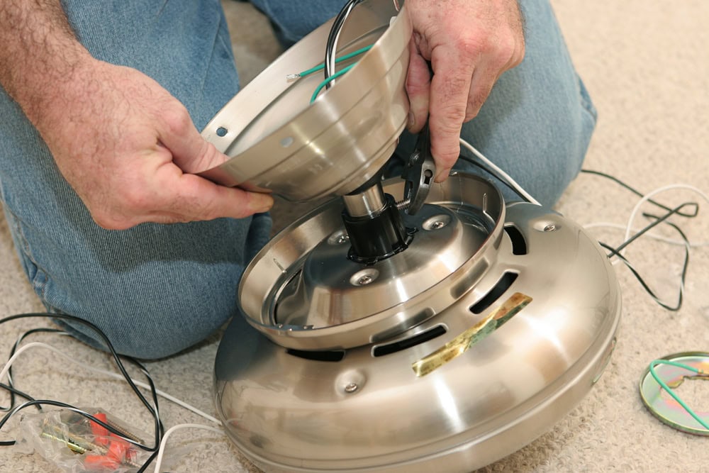 electrician assembling a ceiling fan motor