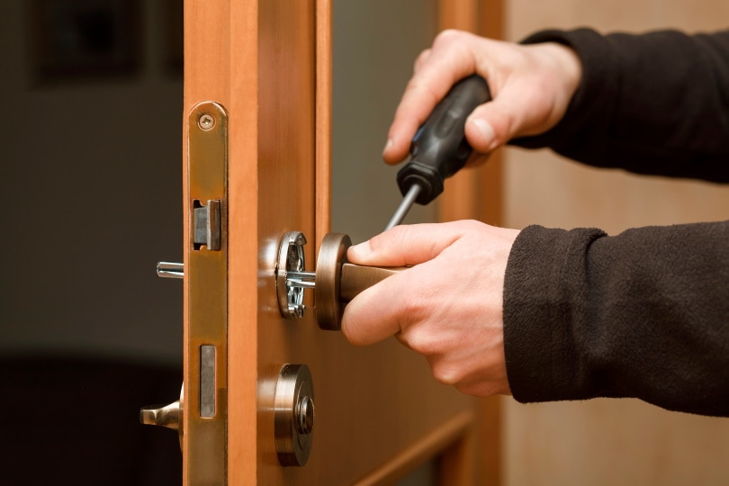 handyman fixing door knob