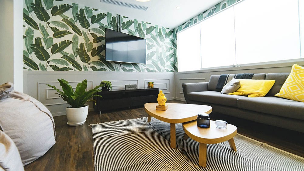 living room with leaves wallpaper
