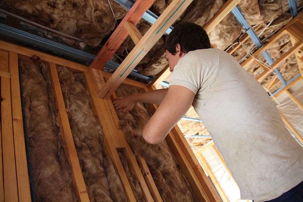 man installing insulation