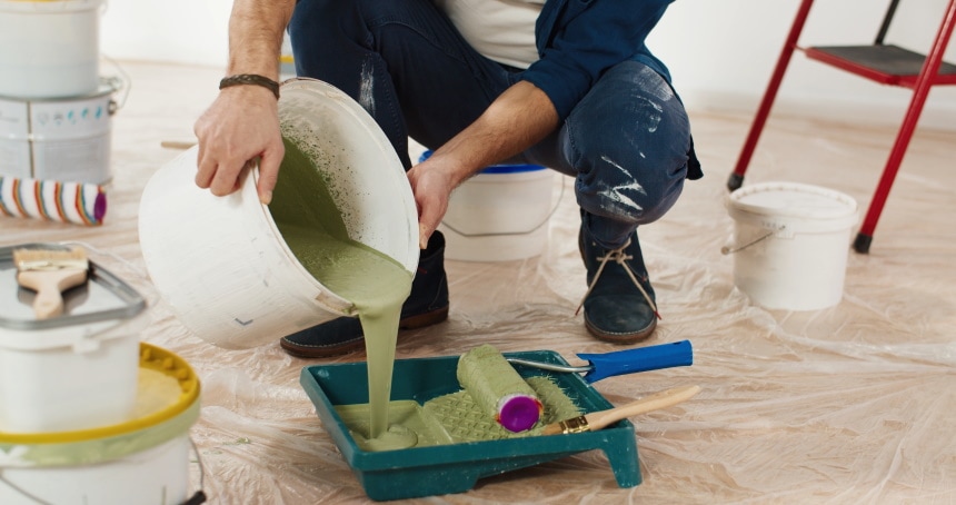 man mixing green paint