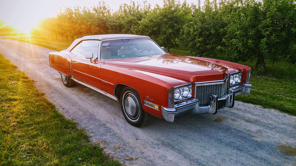 red cadillac on the road