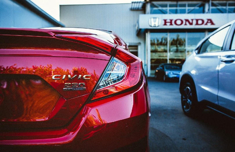 red honda civic parked at the store
