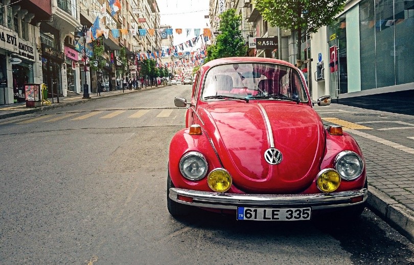 red volkswagen car parked on the side of the road