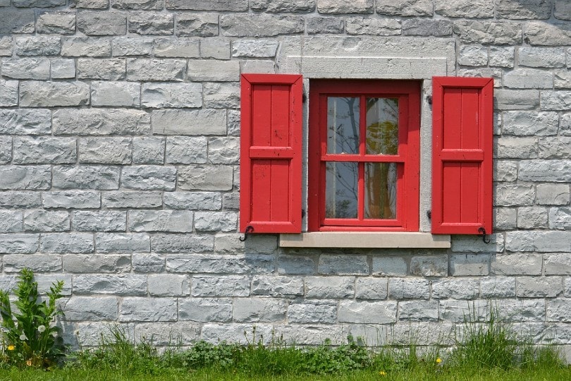 red window in a brick house