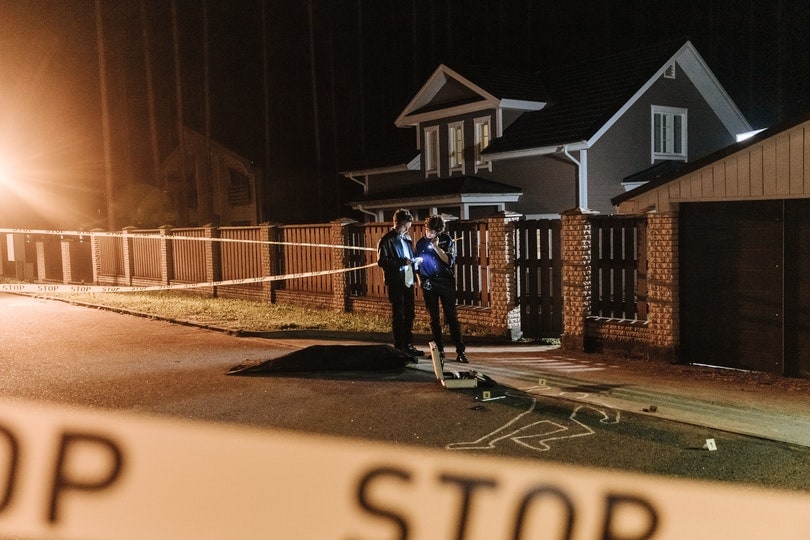 two man investigating a crime scene