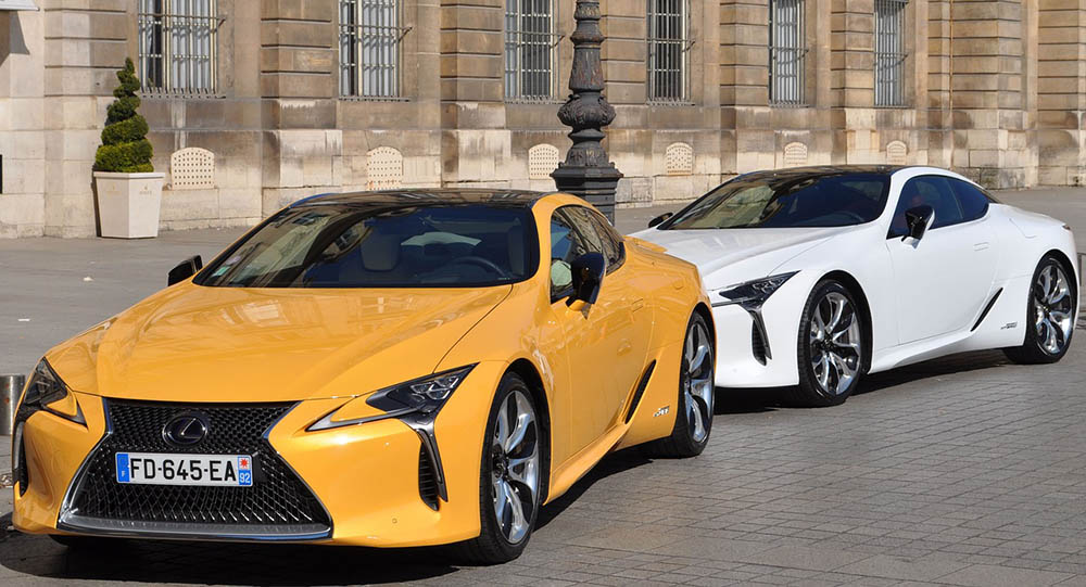white and yellow lexus cars