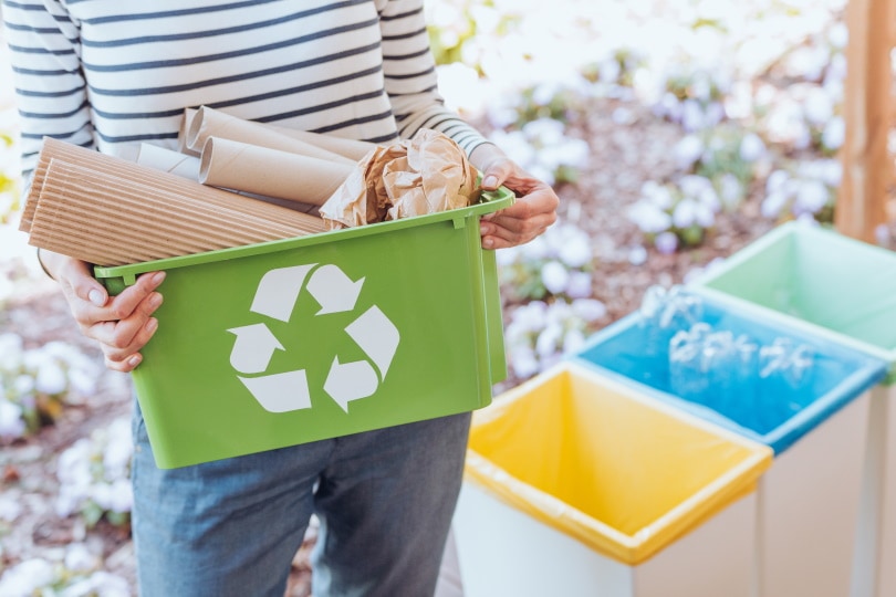 woman holding recycling bin