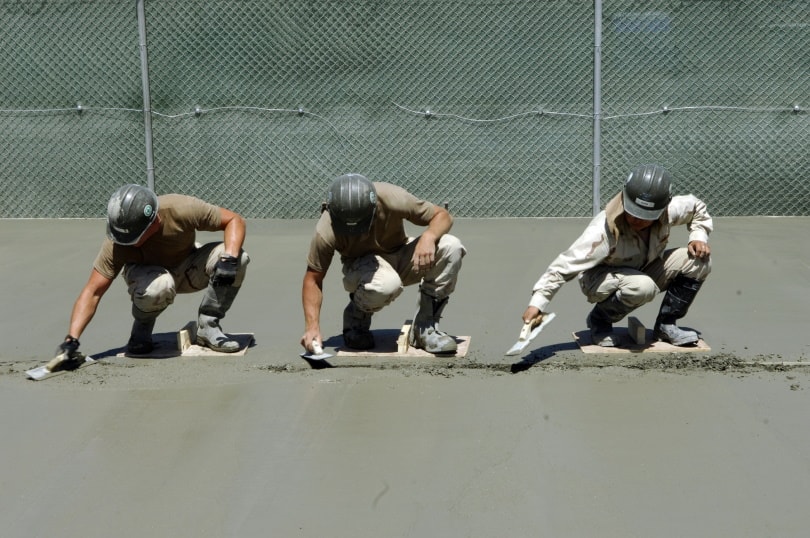 worker smoothing concrete