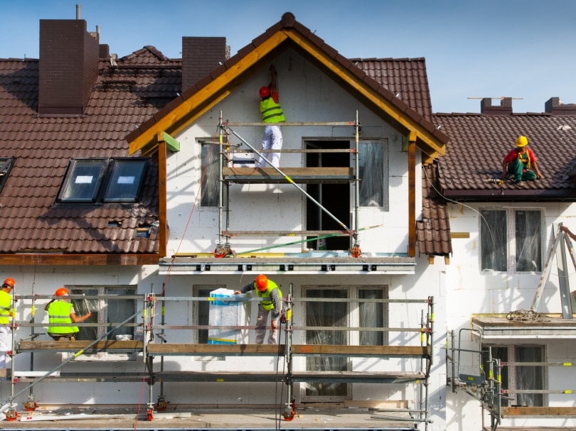 workers painting the house