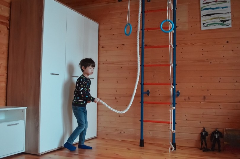 young boy playing rope games in his room