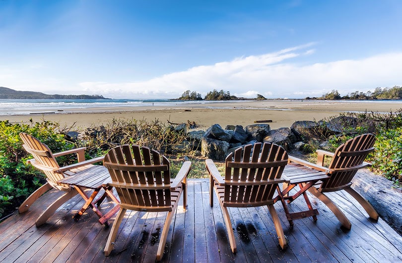Adirondack chairs facing the seashore