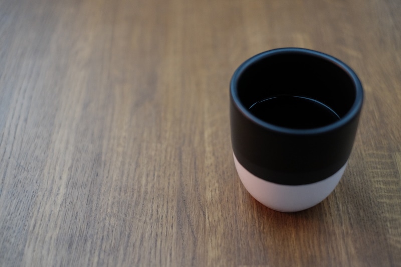 Cup of coffee on pecan table top