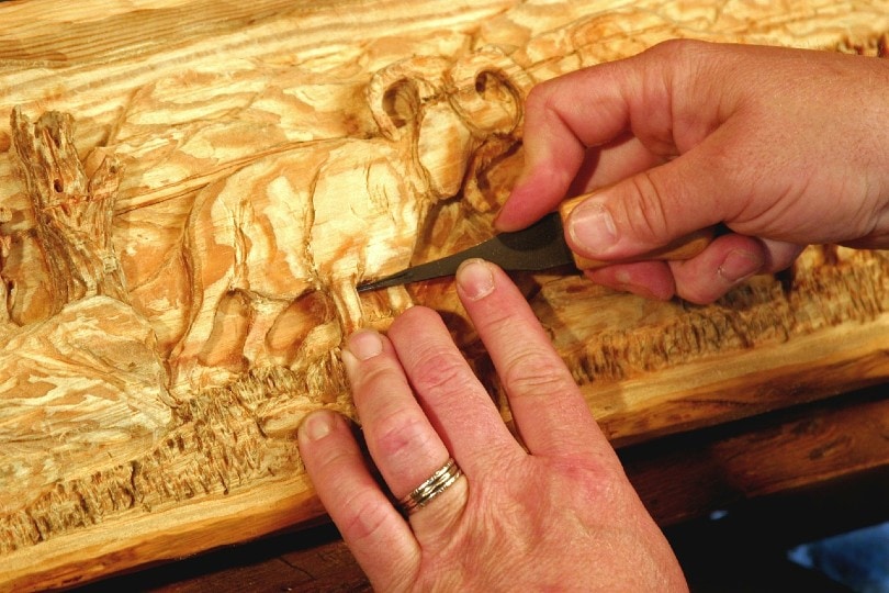 a talented artist carving wood
