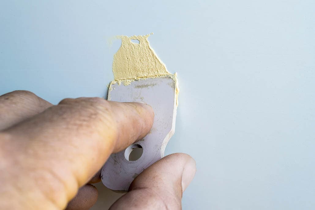 applying filler to the door