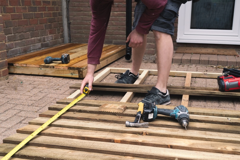 carpenter measuring wood