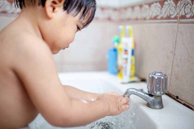 child washing hands
