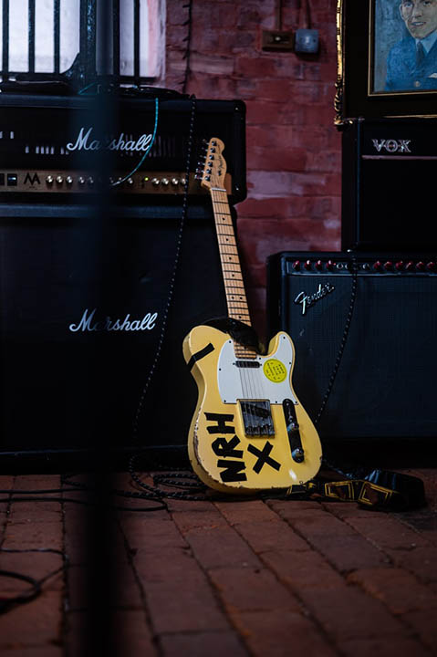 electric guitar on brick floor