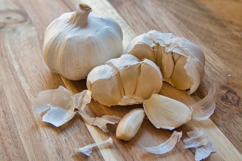 garlic cloves on wooden table