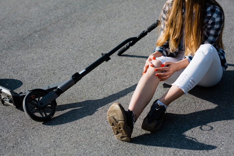 girl sitting on the road