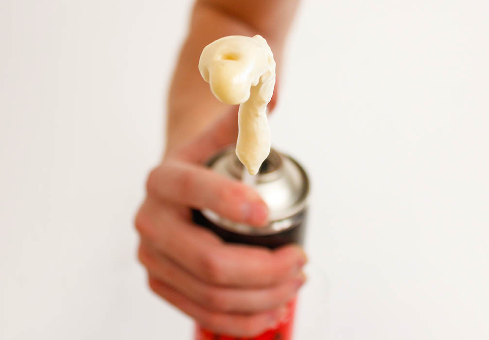 hand holding an expanding foam applicator
