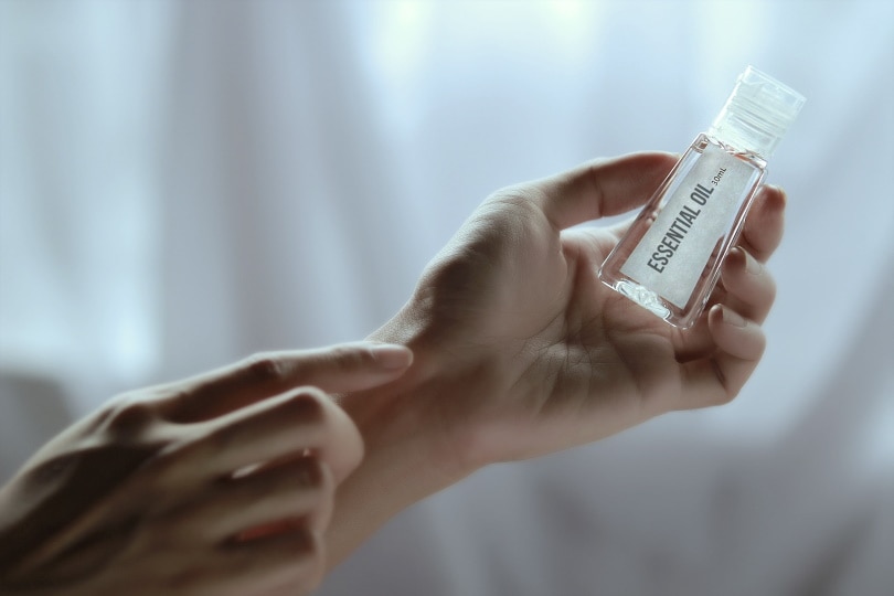 man holding essential oil