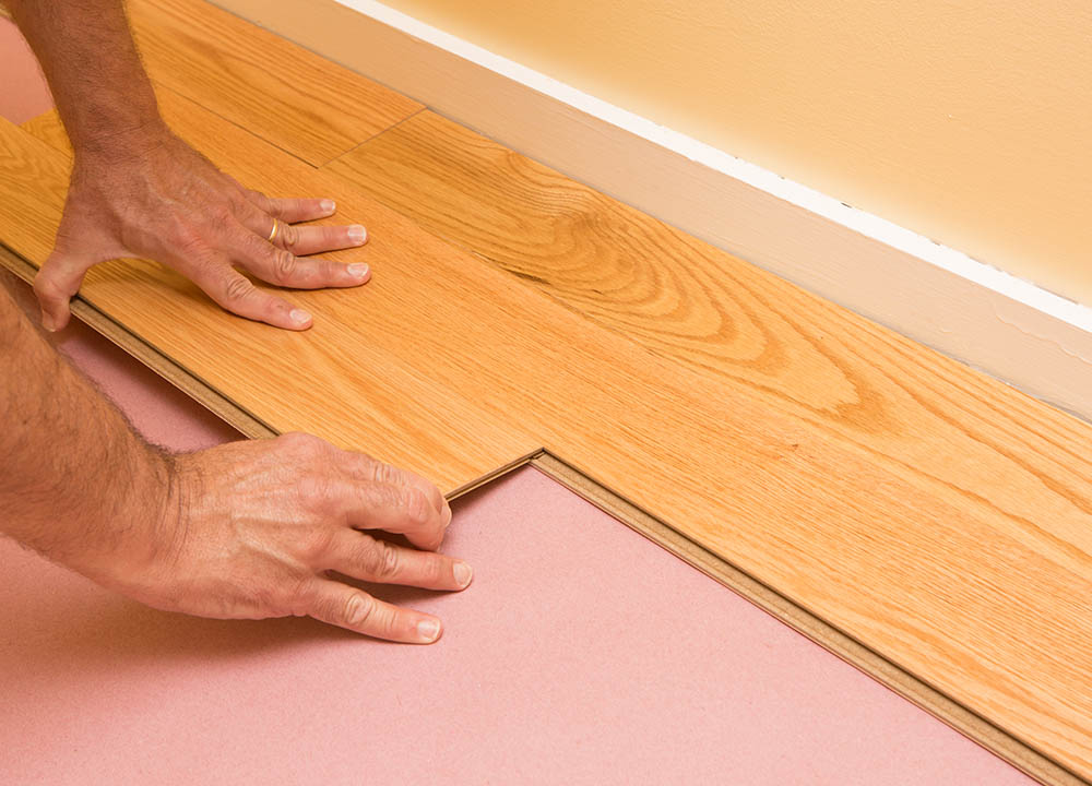 man installing engineered hardwood planks