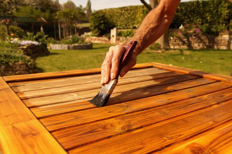 man painting door