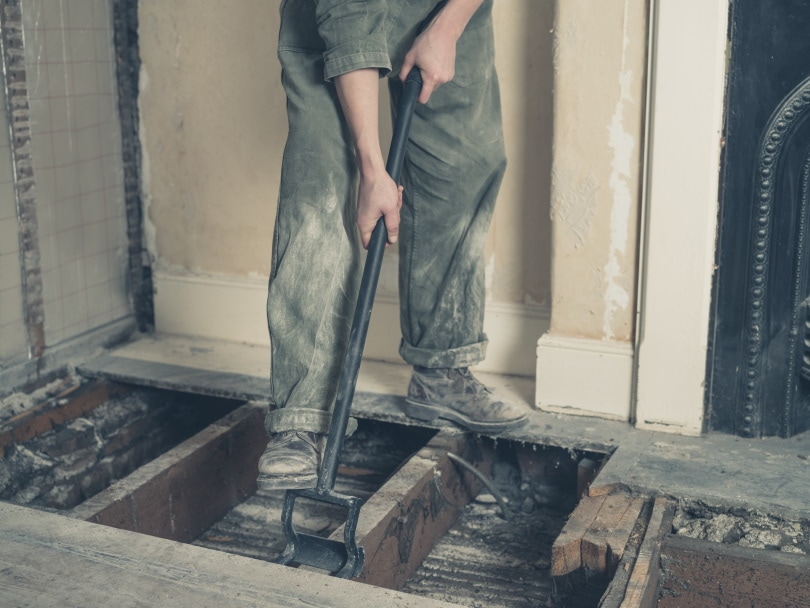 man taking up floor boards