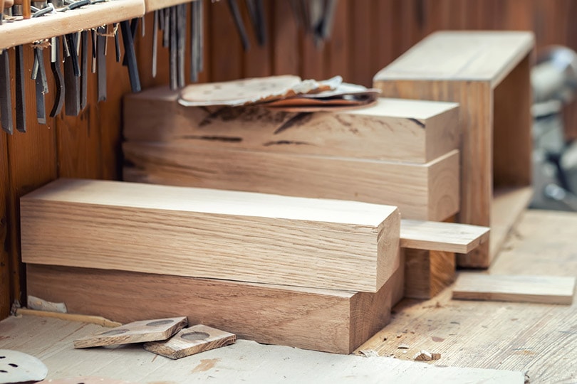 oak wooden bar blocks stacked at carpentry woodwork workshop with tools
