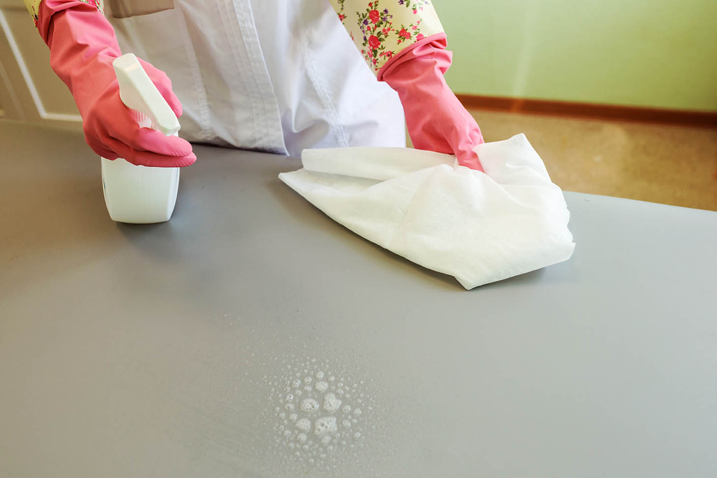 person spraying on sofa