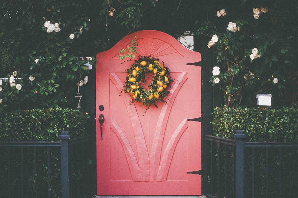 pink door with wreath