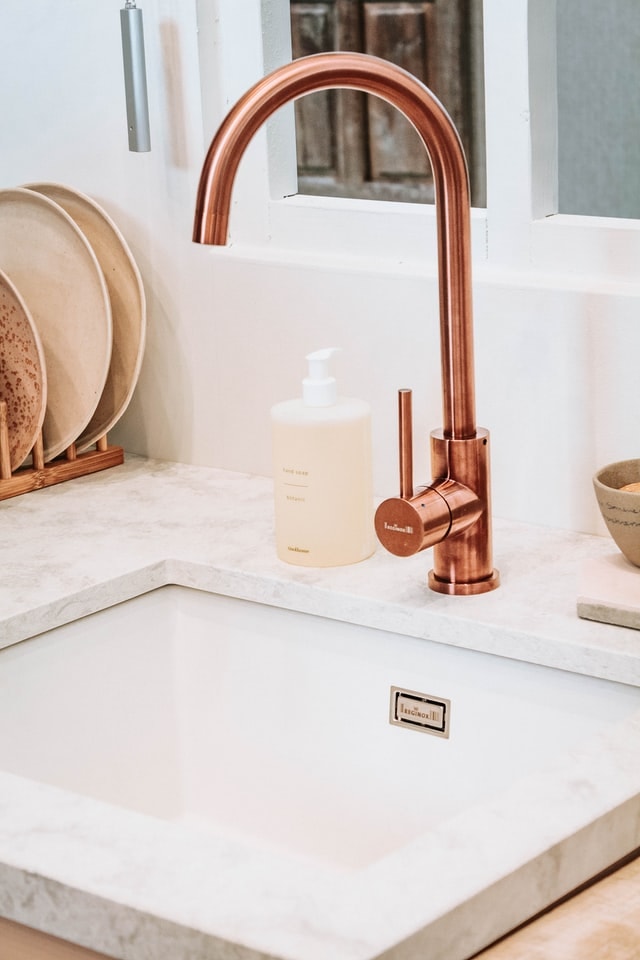 undermount kitchen sink with brass faucet