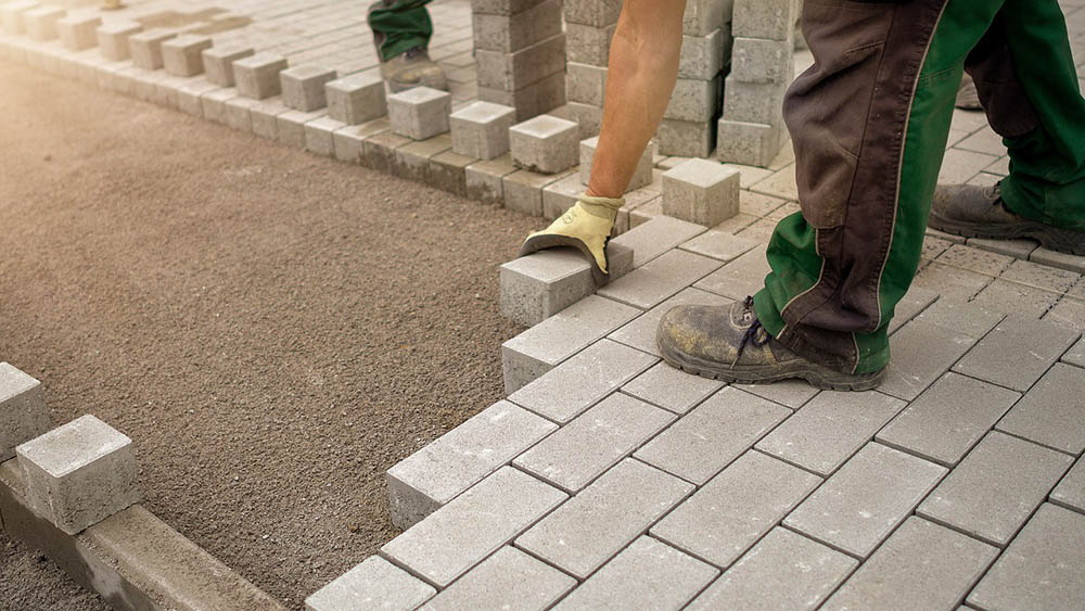workers installing brick flooring