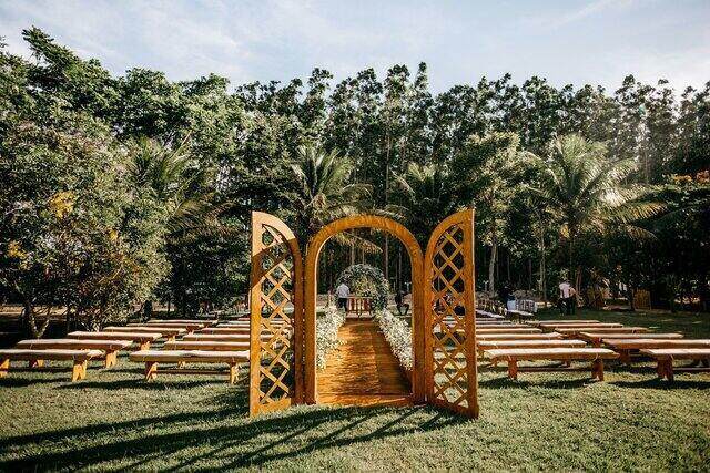 Ceremony garden arbor green grass and trees wedding