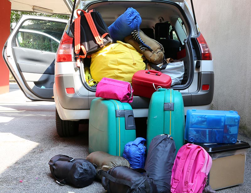 car overloaded with suitcases and duffle bag for family travel