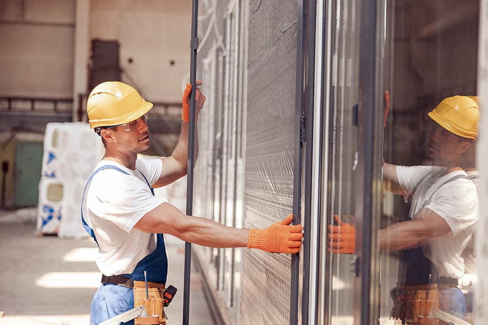construction worker installing sliding glass door