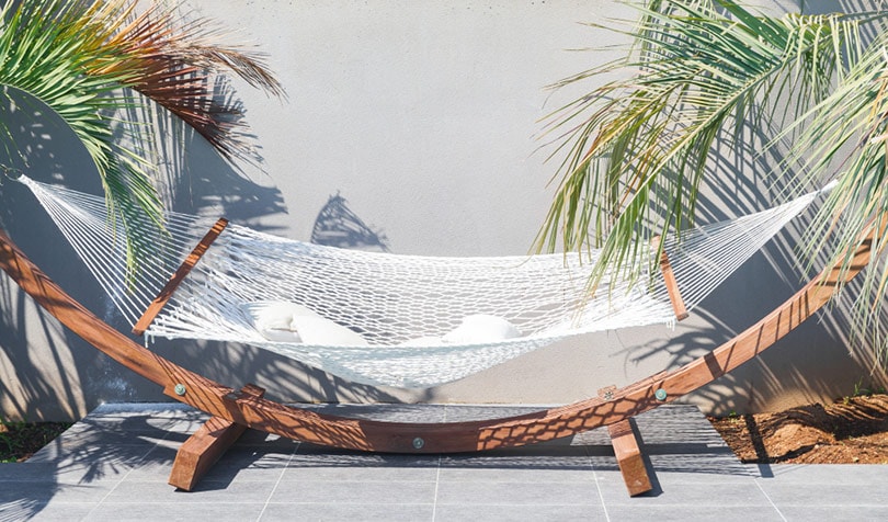 empty white hammock with pillows