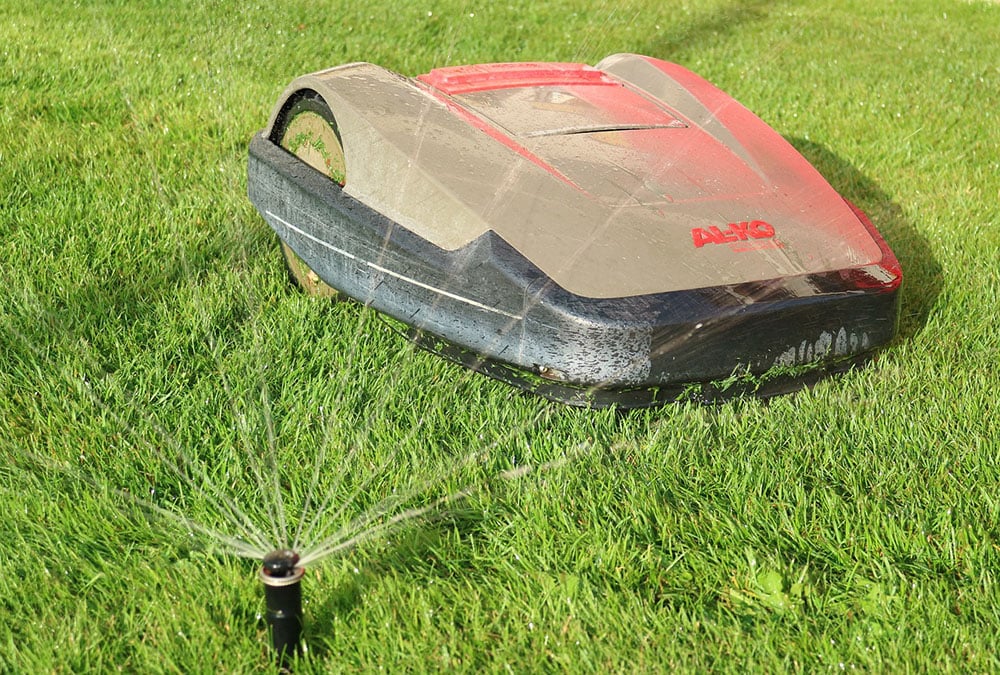 gear driven sprinkler near a robotic lawnmower