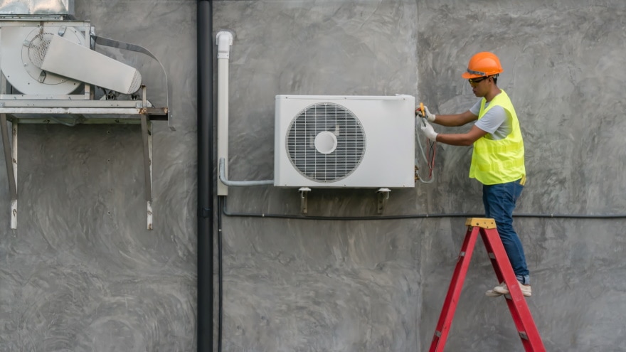 man checking air conditioning unit