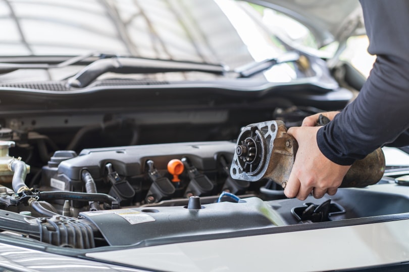 man holding starter motor